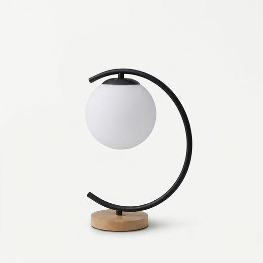 Zentrolia glass bedside table lamp with gold base glowing on nightstand